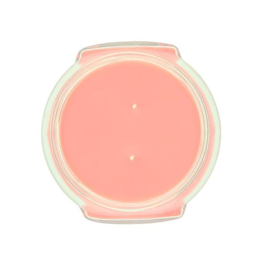Tyler Candle Company 22 oz candle with coral pink wax and two visible wicks