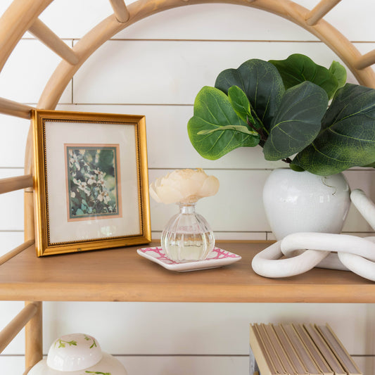 Greenleaf Gifts Spa Springs Flower Diffuser styled on wooden shelf with white peony flower in clear ribbed glass bottle