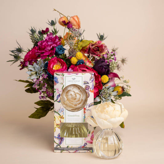 Greenleaf Grandiflora diffuser displayed with vibrant mixed flower arrangement in pink, red, yellow, and purple tones