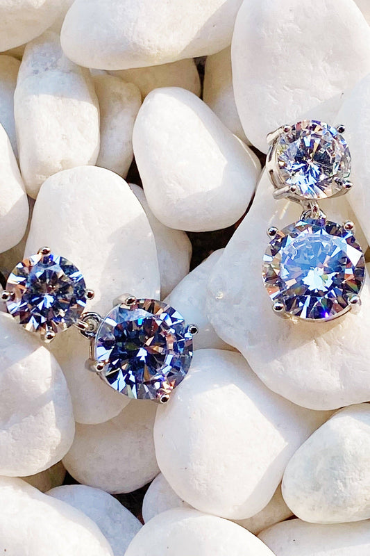 Ellison+Young double diamond dangle earrings close-up on white quartz, two stacked round-cut sapphire and diamond stones per earring