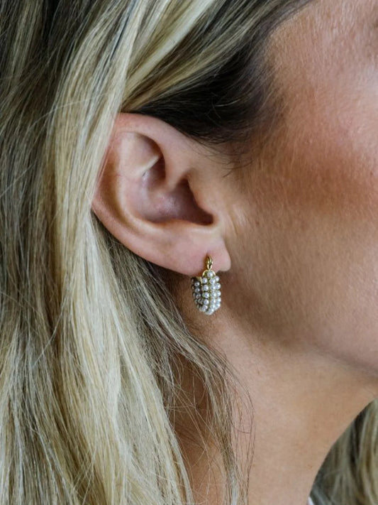 Marrin Costello Audrey Huggies worn on ear, pearl beaded hoops with gold accents