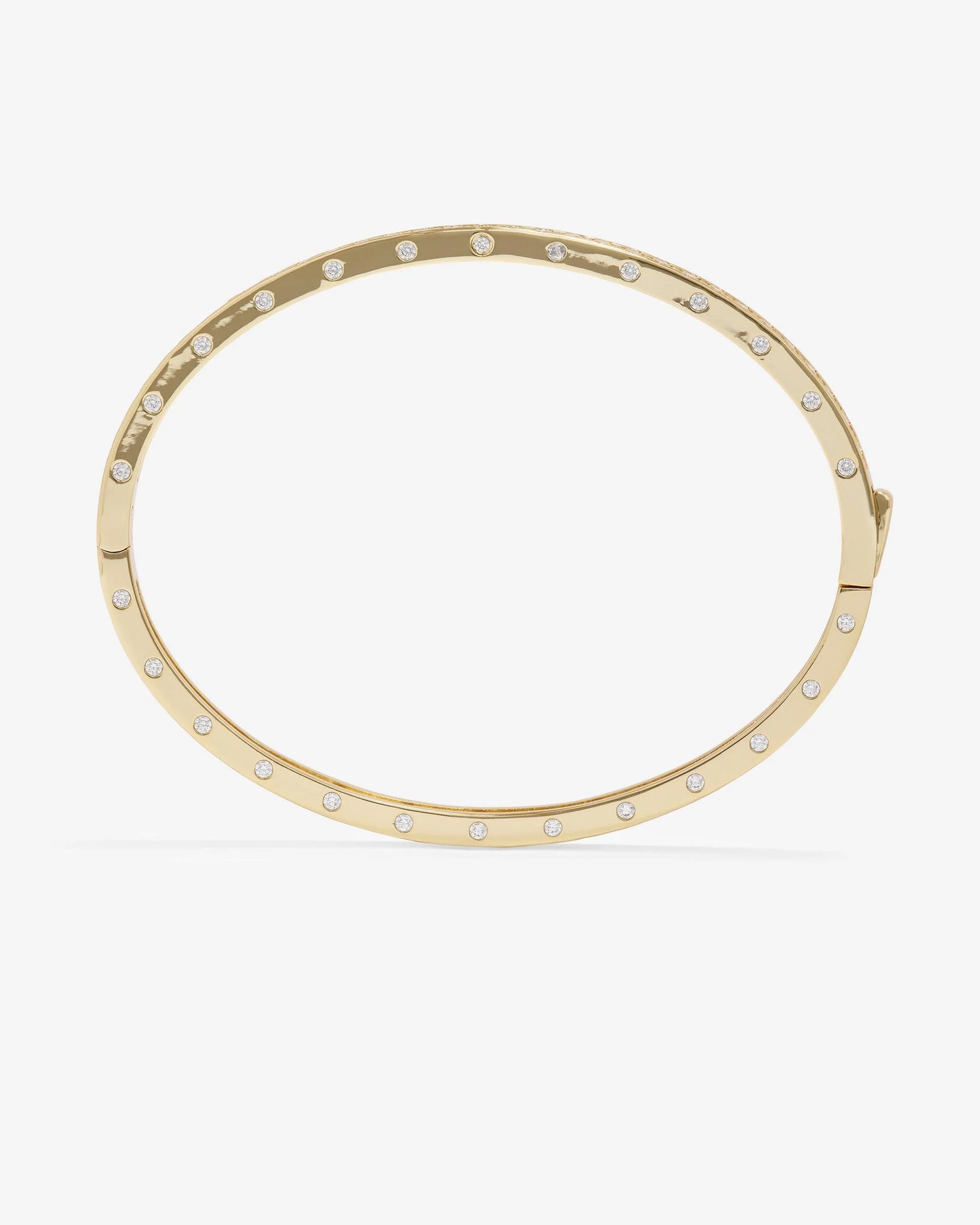 The Melinda Maria Ashley Pave Cuff Gold is an elegant 18k gold plated oval cuff bracelet by Melinda Maria, featuring evenly spaced small round pavé simulated diamonds along its outer edge for a touch of timeless sophistication to any ensemble.
