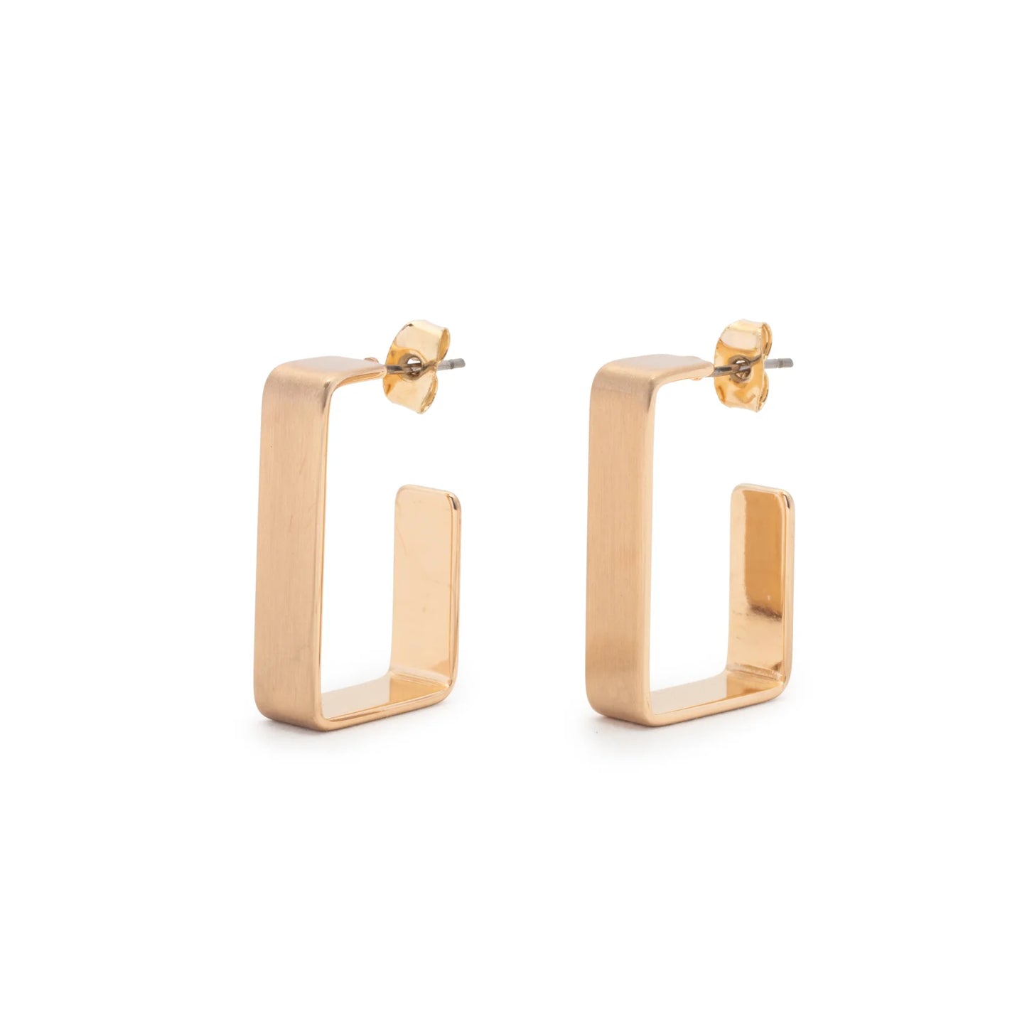 The Leslie Curtis Emmie Earrings by Leslie Curtis are a pair of brushed gold rectangular hoop earrings with straight edges, featuring a rectangle post and secure stud backings. Viewed at an angle, they showcase a geometric, modern design. Each hoop measures approximately 1 inch in length.
