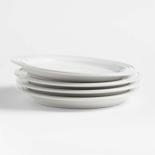 Stack of four Le Creuset white salad plates shown from the side