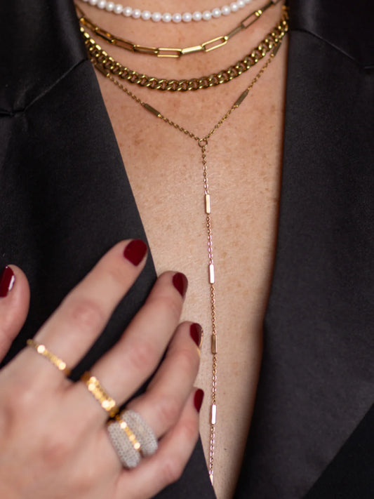 Marrin Costello Regina Lariat Necklace in gold worn layered with other necklaces