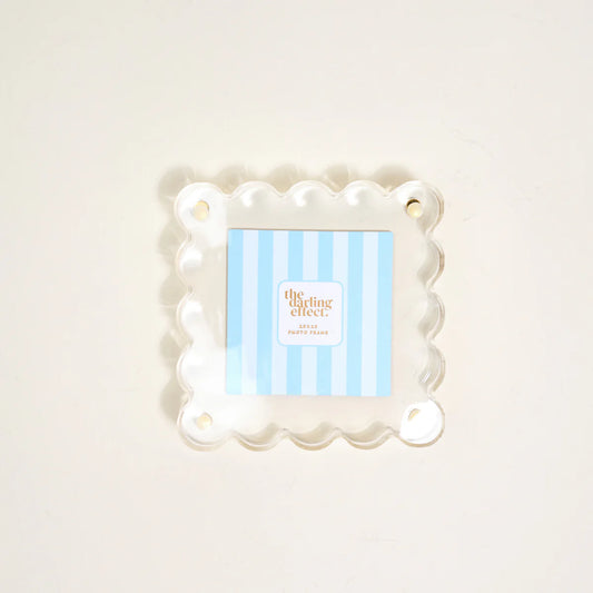 The Darling Effect Little Moments square acrylic picture frame in white with scalloped edges and brass hardware