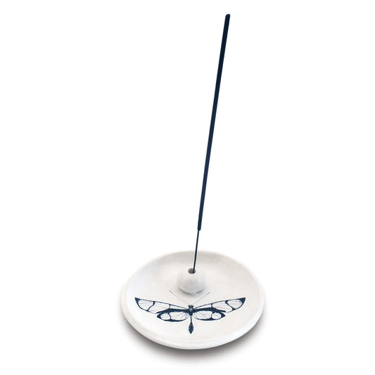 Skeem citronella incense holder with navy incense stick inserted, showing dragonfly detail
