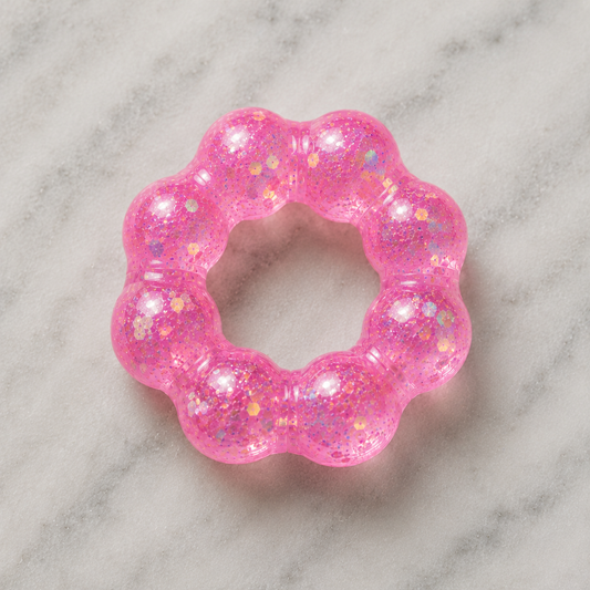 Feelzies Original Squishy Bracelet in hot pink with glitter and metallic accents, flower-shaped design