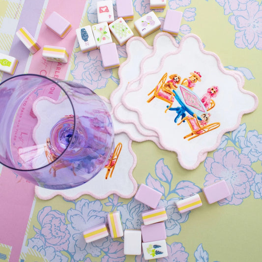 Taylor Paladino Dogs Playing Mahjong Cocktail Squares displayed with matching tiles and purple spinner on patterned surface