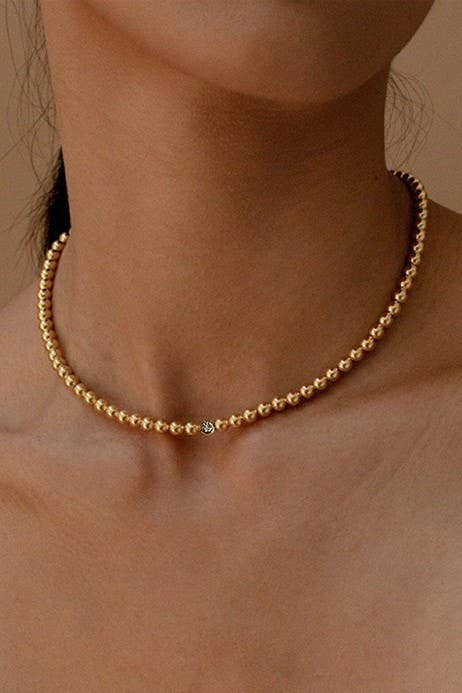 JOSSLYN by wall to wall gold beaded necklace with crystal accent detail on collarbone