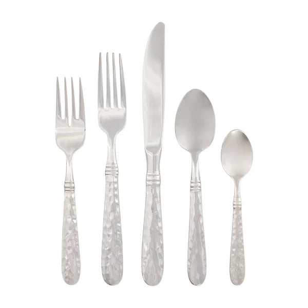 Five pieces of Vietri "Martellato" Stainless Flatware—salad fork, dinner fork, knife, soup spoon, and teaspoon—each featuring textured handles by Vietri, arranged in a row against a white background.