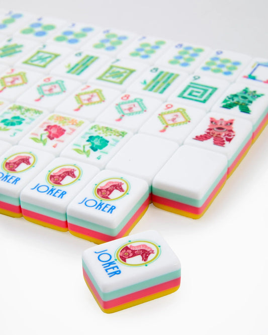 Oh My Mahjong Pippa Tiles by Oh My Mahjong showcase modern, colorful mahjong tiles with pastel edges, charming floral patterns, and a playful Joker tile featuring a whimsical pink horse illustration.