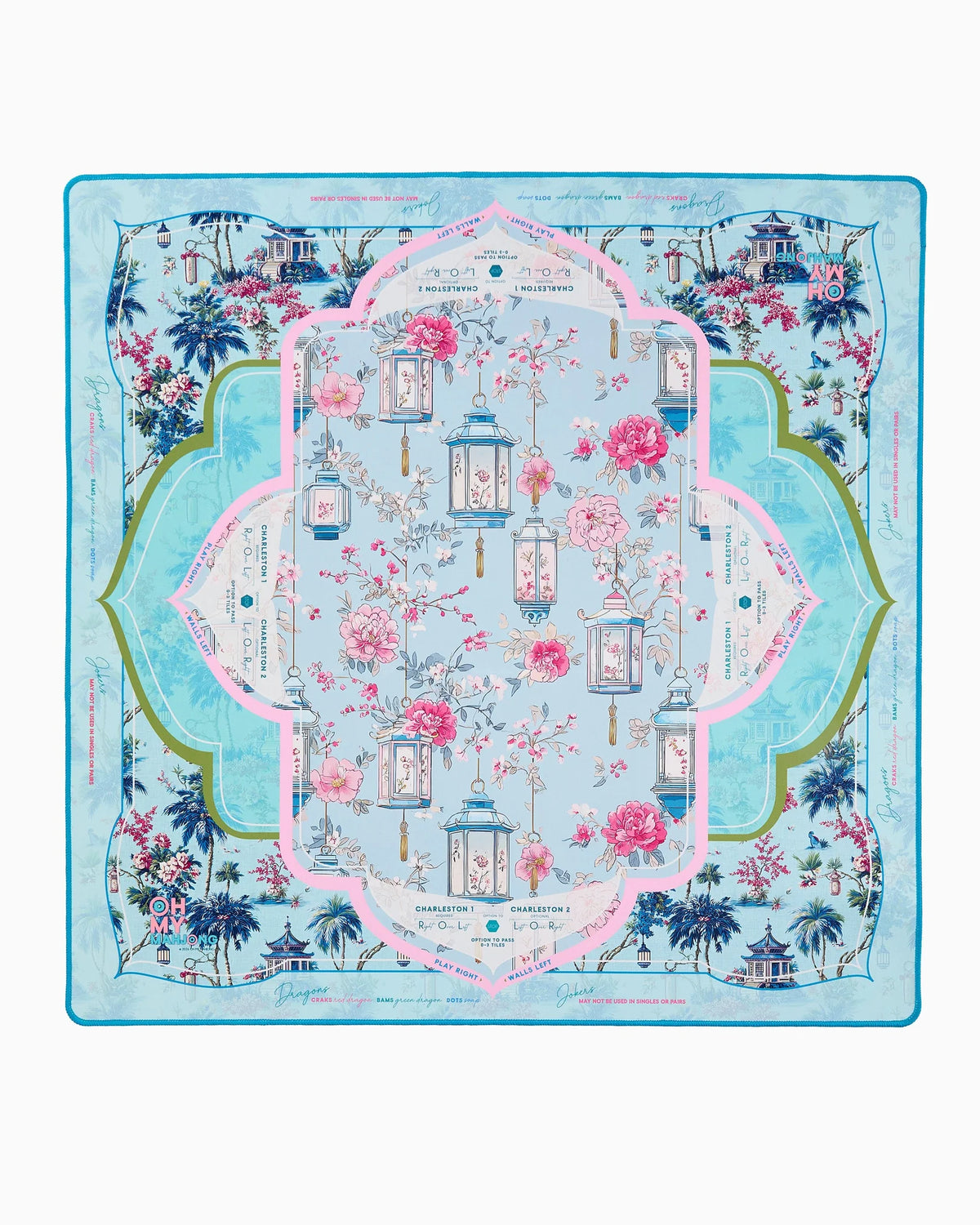 Introducing the Oh My Mahjong Radiance Mat in Tube by Holmes Stationers and Gifts—a decorative silk mat featuring a floral and lantern motif, bordered in blue, green, and pink. Inspired by chinoiserie mahjong mats, its elegant background showcases palm trees, graceful architecture, and flowing cursive script for an exquisite finish.