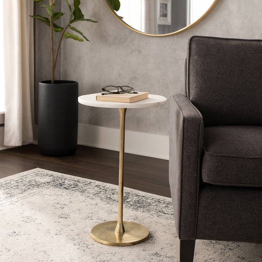 Sagebrook Home gold and white marble top end table beside dark upholstered chair