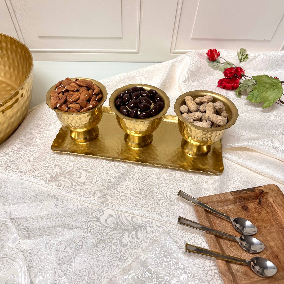 India Handicrafts Inc gold serving set with three bowls holding nuts, decorated table setting