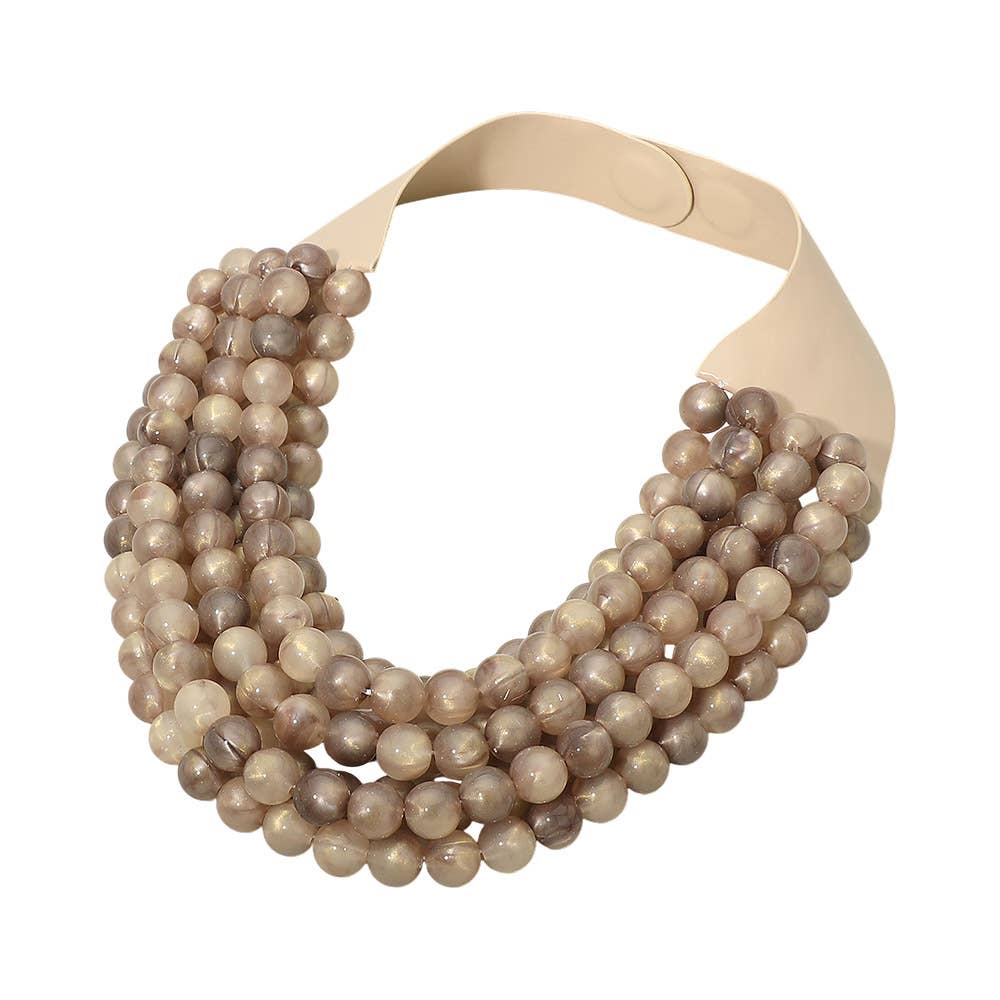 The Sensibling Corp. Marbled Ball Beaded Multi Layered Faux Leather Magnetic Collar Necklace features five strands of glossy, marbled taupe beads attached to a wide, smooth light tan faux leather collar with a convenient magnetic closure, creating an elegant layered statement look.