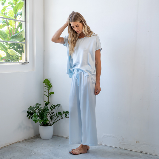 Woman wearing PJ Harlow Jolie Capri set in light blue, styled full-length indoors