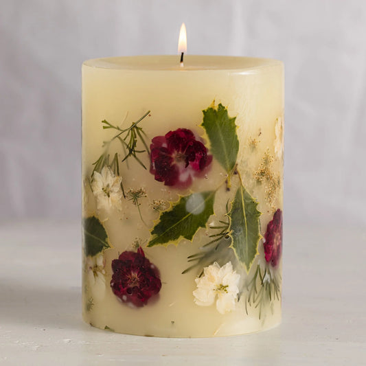 Rosy Rings Signature Accent Botanical Candle in cream with embedded burgundy and white flowers and green leaves, lit flame visible