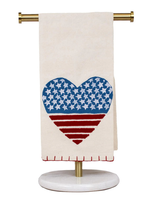 The Royal Standard Love of America Hand Towel with stars-and-stripes heart design on cream linen, on brass stand