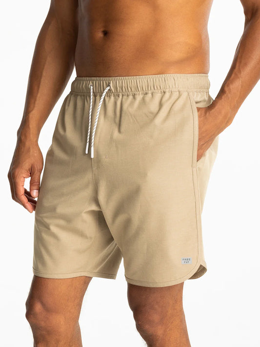 Free Fly Men's Reverb Short in cream with drawstring and side pocket, front view