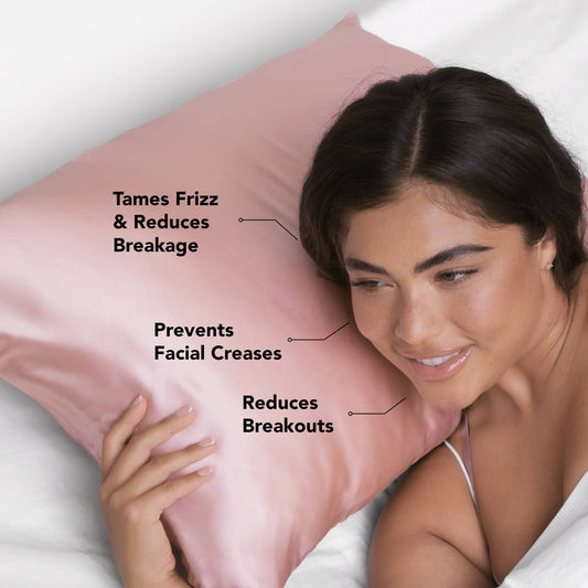 Woman resting head on blush satin pillowcase with benefits labeled: tames frizz, prevents facial creases, reduces breakouts