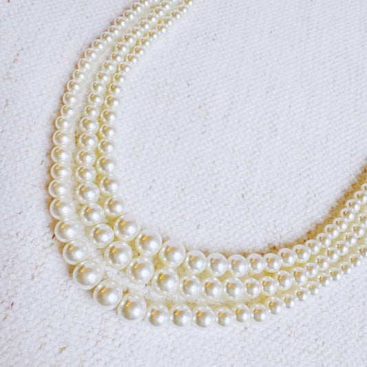 Ellison+Young Perfect Pearl Strands Necklace showing three strands of cream and gold pearls layered together