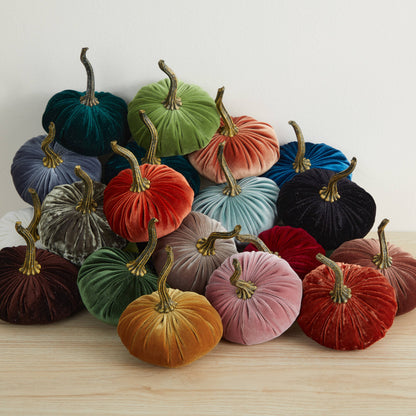 A charming collection of Your Heart’s Content - Pumpkin Small Velvet decor in an array of colors—green, blue, orange, yellow, red, and purple—arranged on a light wooden surface against a white background; ideal for a Valentine’s mantel, autumn table display, or as a thoughtful gift.