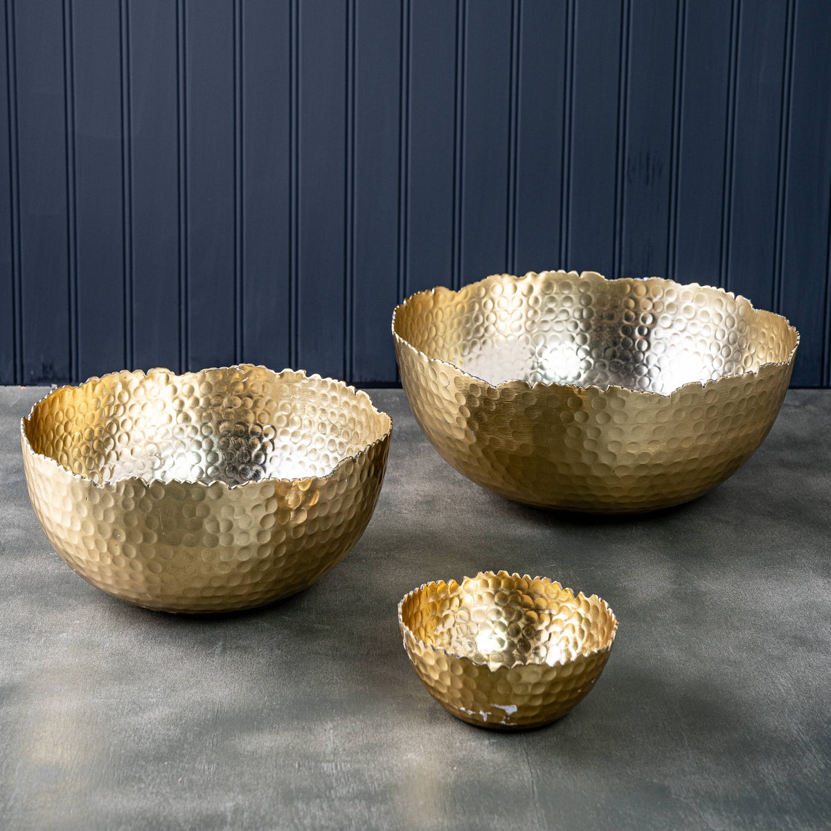 Three India Handicrafts Inc Gilded Hammered Bowls in graduated sizes displayed together, gold finish