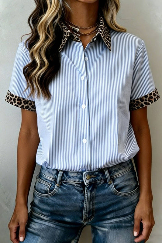 A woman wearing the 66DISCO Leopard Trim Striped Button-Down Short Sleeve Shirt, featuring blue and white pinstripes with standout leopard print accents on the collar and sleeve cuffs, styled effortlessly with classic blue jeans for a modern western-inspired look.
