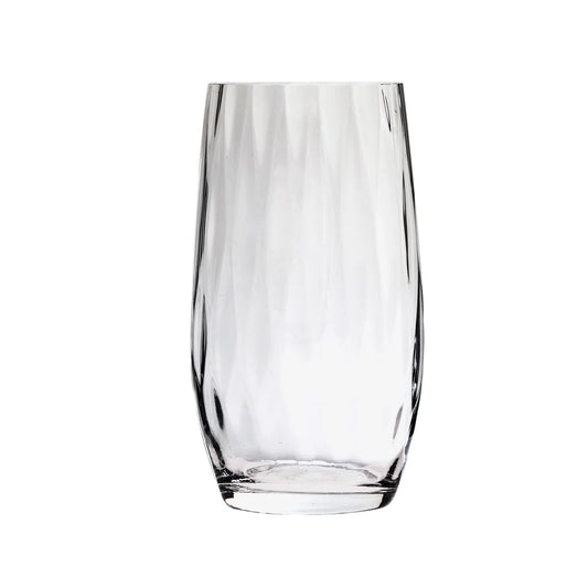 A clear, empty Skyros Designs "Abigail" glass tumbler with a faceted textured surface stands upright on a white background.