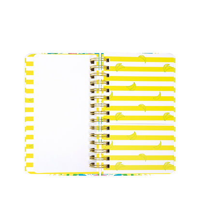 An open Lilly Pulitzer by Lifeguard Press - Medium 17 Month Agenda, Lovely Lilly, features a left page that is blank and a right page adorned with yellow stripes and small banana illustrations.