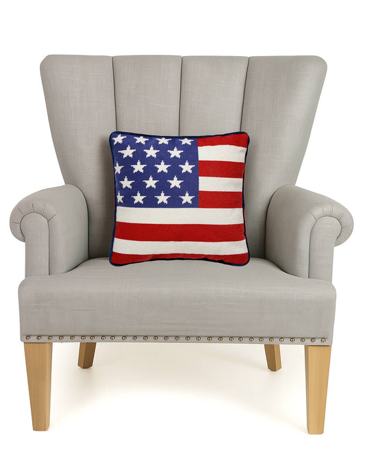American Flag pillow styled on cream wingback chair with wooden legs