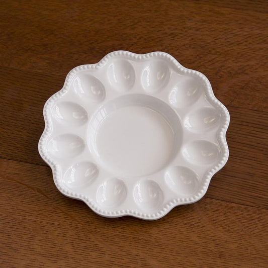 Beatriz Ball VIDA Alegria white deviled egg platter with scalloped rim and twelve egg-shaped wells surrounding center bowl