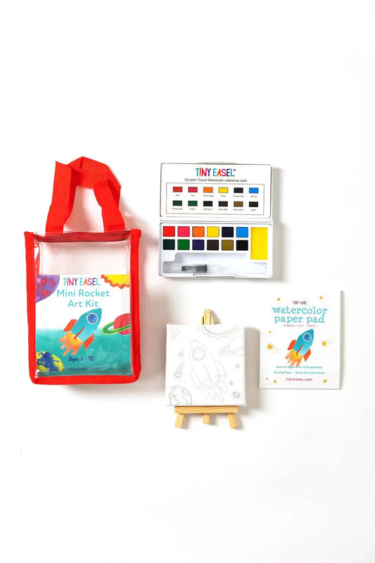 Tiny Easel Mini Rocket Art Kit with red tote bag, watercolor palette, wooden easel, and coloring pad