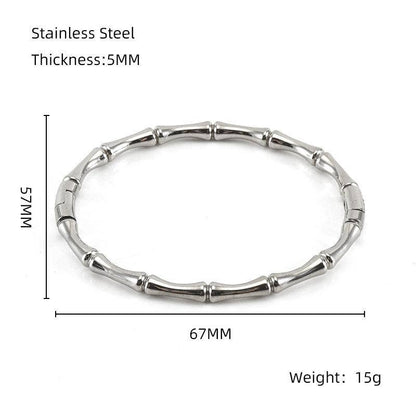 The Mio Queena Multi-style 18K Gold-plated Stainless Steel Bangle – FGS features a unique bamboo-inspired design in silver stainless steel, measuring 5mm in thickness with an inner diameter of 67mm, outer width of 75mm, and weighing 15g. Presented against a white background with labeled measurements, this stylish bangle by Mio Queena is an ideal jewelry gift for any occasion.