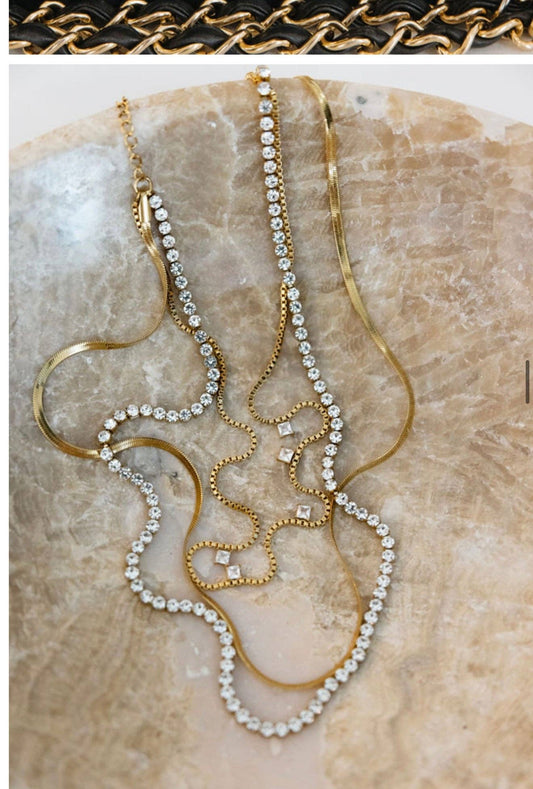 Chansut Pearls Leah necklace layered strands of gold chains with rhinestones and pearls on stone