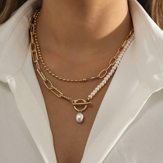 JOSSLYN by wall to wall pearl mix double layer toggle necklace layered with beaded and pearl strands, worn with white shirt