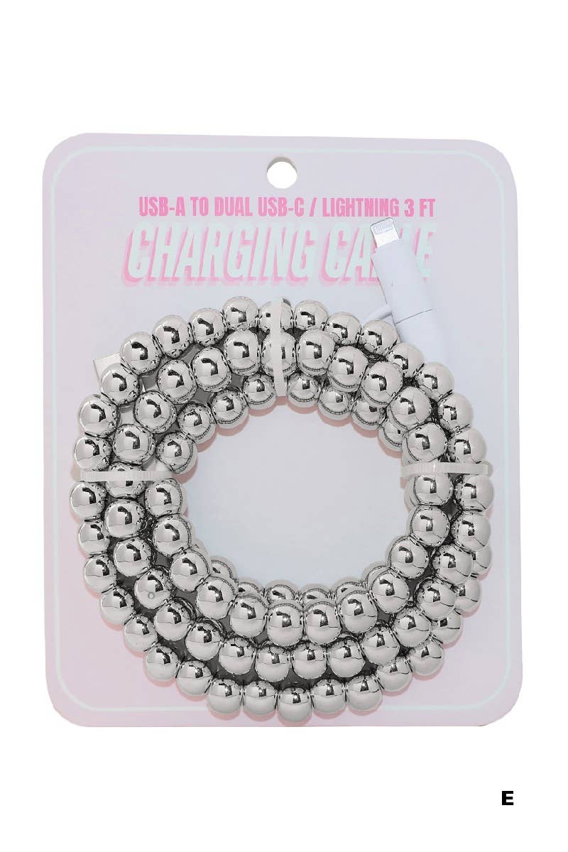 A coiled silver beaded fast charging cable by 42POPS rests atop a pink and white card labeled "USB-A to Dual USB-C / Lightning 3 FT Charging Cable." The 42POPS Beaded Dual USB Fast Charging Cable offers rapid charging and universal compatibility for your devices.