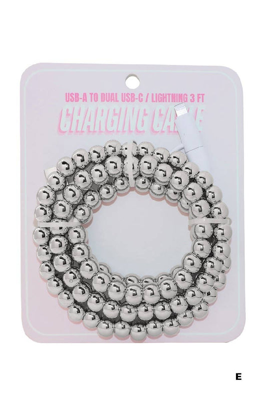 A coiled silver beaded fast charging cable by 42POPS rests atop a pink and white card labeled "USB-A to Dual USB-C / Lightning 3 FT Charging Cable." The 42POPS Beaded Dual USB Fast Charging Cable offers rapid charging and universal compatibility for your devices.