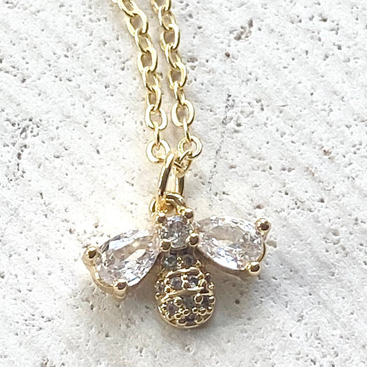 VB&CO Designs gold bee necklace with crystal wings and textured body on gold chain closeup