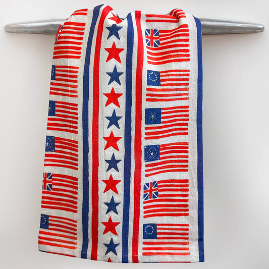 Taylor Paladino Fourth of July Tea Towel with red and white striped flags, stars, and Union Jack pattern in red, navy, and cream