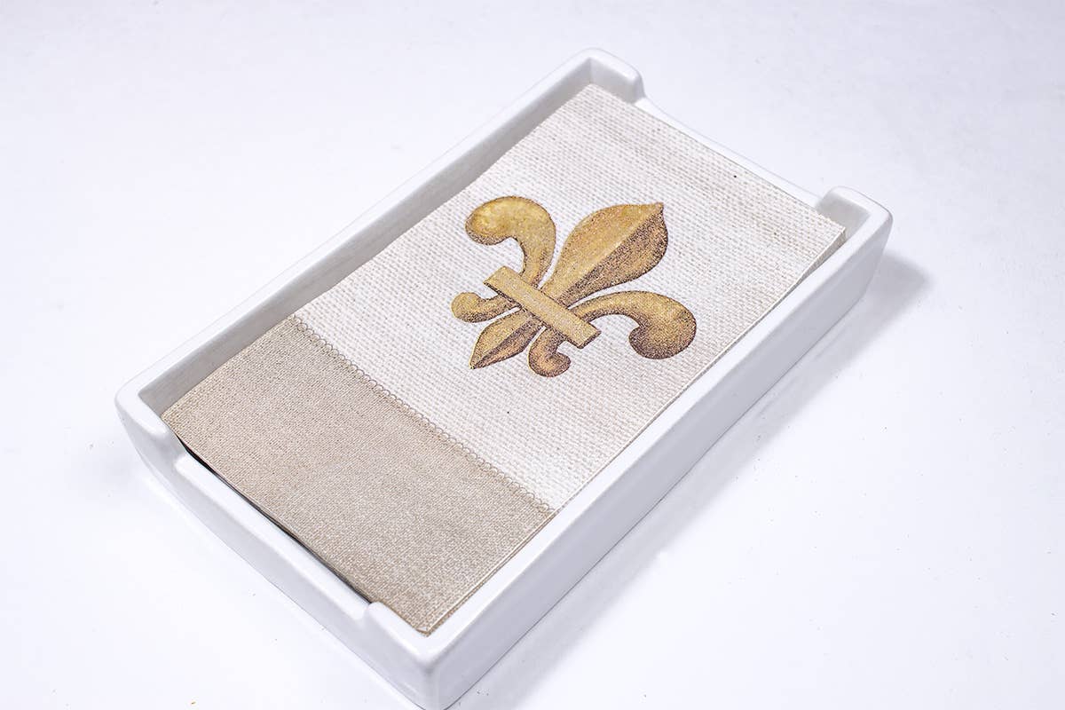 The Royal Standard Classic Guest Napkin Holder filled with beige and cream napkins featuring gold fleur-de-lis design