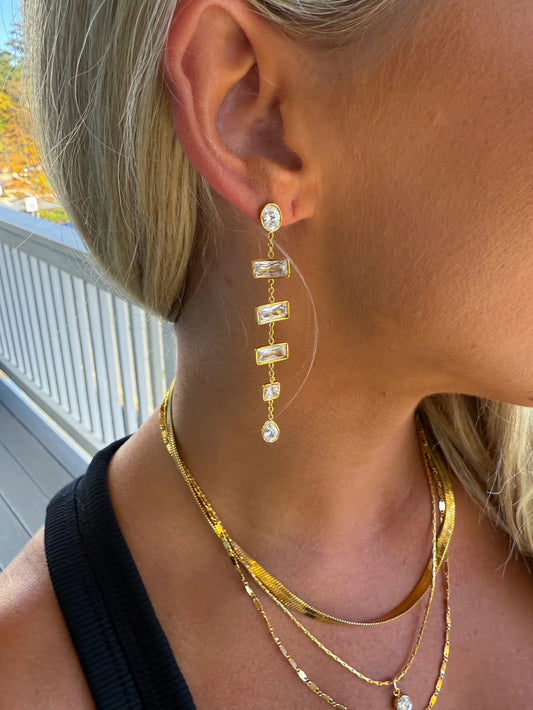 CHANSUTTPEARLS Diamond Collar Duster earrings worn, featuring gold rectangular stones and pearl drops