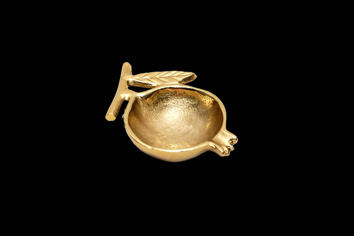 Gold Pomegranate Bowl by India Handicrafts Inc with leaf handle and spout, angled view