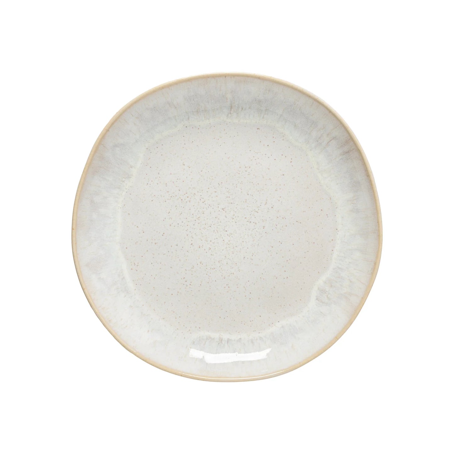 The Casafina “Evissa - Sand Beige” Dinner Plate by Casafina is a round ceramic plate with a slightly irregular edge and a light beige, speckled glaze, featuring a subtle gradient pattern along the rim.