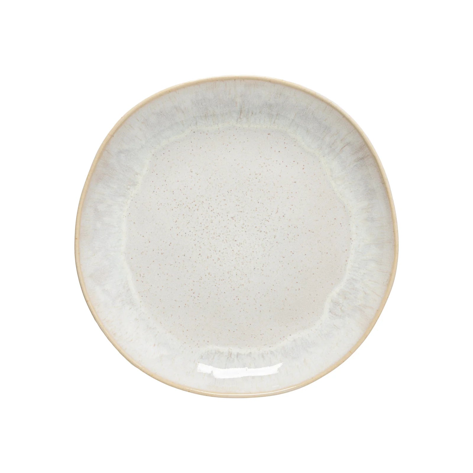 The Casafina “Evissa - Sand Beige” Dinner Plate by Casafina is a round ceramic plate with a slightly irregular edge and a light beige, speckled glaze, featuring a subtle gradient pattern along the rim.