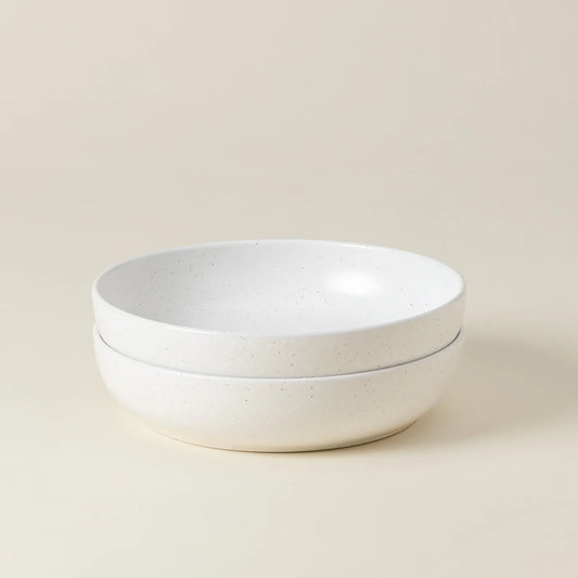 Two stacked Casafina “Pacifica - White” pasta bowls with a matte finish, displayed on a plain light beige background.