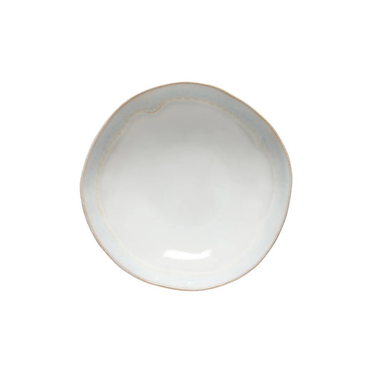 The Costa Nova “Brisa - Salt” Pasta Bowl by Costa Nova is a round, white ceramic bowl with a slightly irregular, wavy rim, displayed from above against a plain white background.