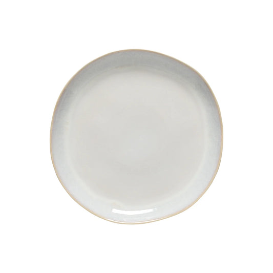 The Costa Nova “Brisa - Salt” Dinner Plate by Costa Nova, featuring a white ceramic finish with slightly uneven, rounded edges, is displayed on a plain white background.