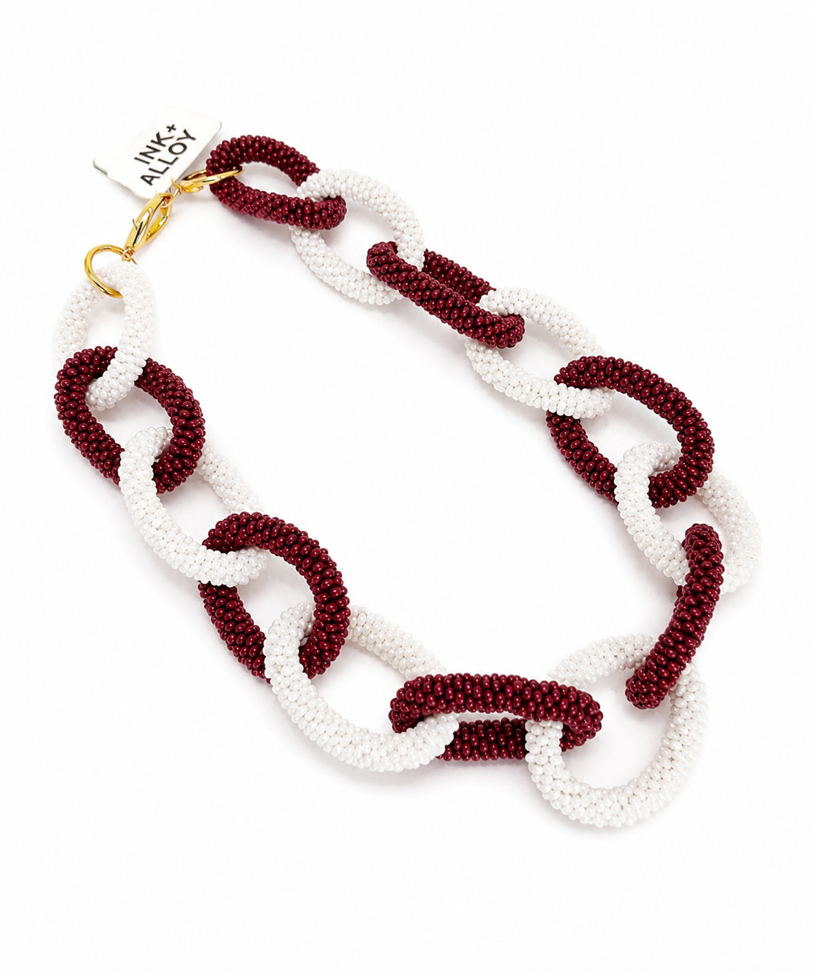 Ink + Alloy Gameday Chain Link necklace in burgundy and cream, flat lay with tag
